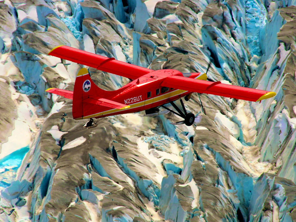 Red DHC-3 Otter plane flying over Arctic ice