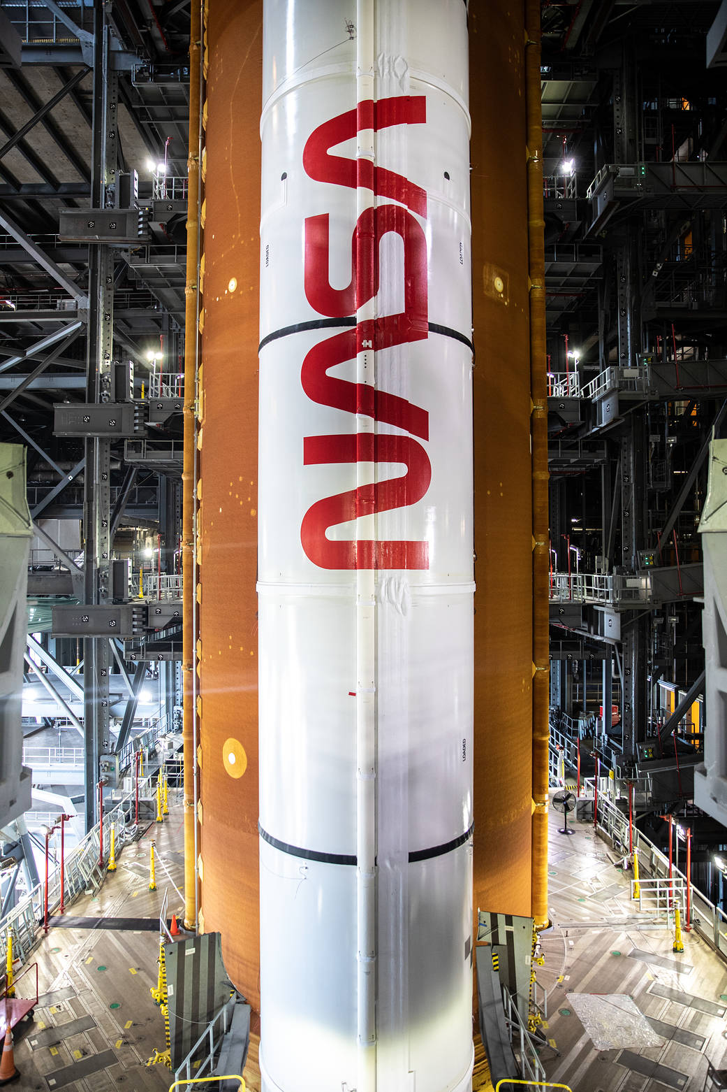 Inside High Bay 3 of the Vehicle Assembly Building at NASA’s Kennedy Space Center in Florida, application of the NASA worm logo is complete on the first of two solid rocket boosters for the Artemis I Space Launch System on March 14, 2022. 