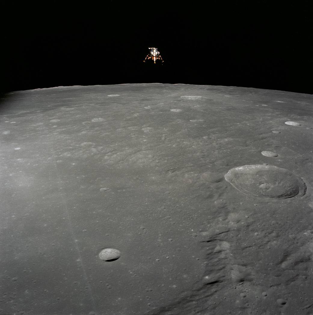 Apollo 12 Lunar Module configured for landing in lunar orbit with vast lunar surface below