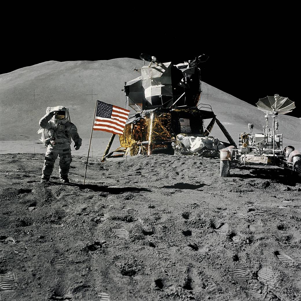 Apollo 15 astronaut Jim Iwrin salutes in this photo on the Moon with the lunar lander, the American flag, and the lunar rover