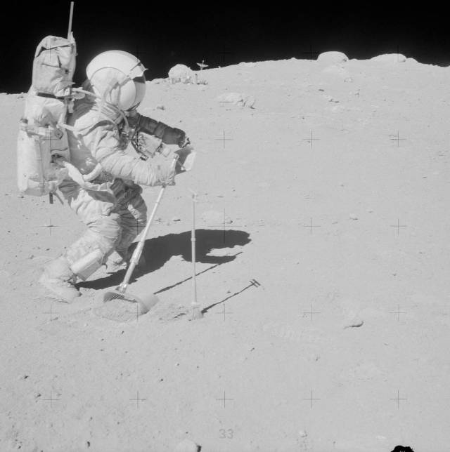 Astronaut in spacesuit walks on lunar surface