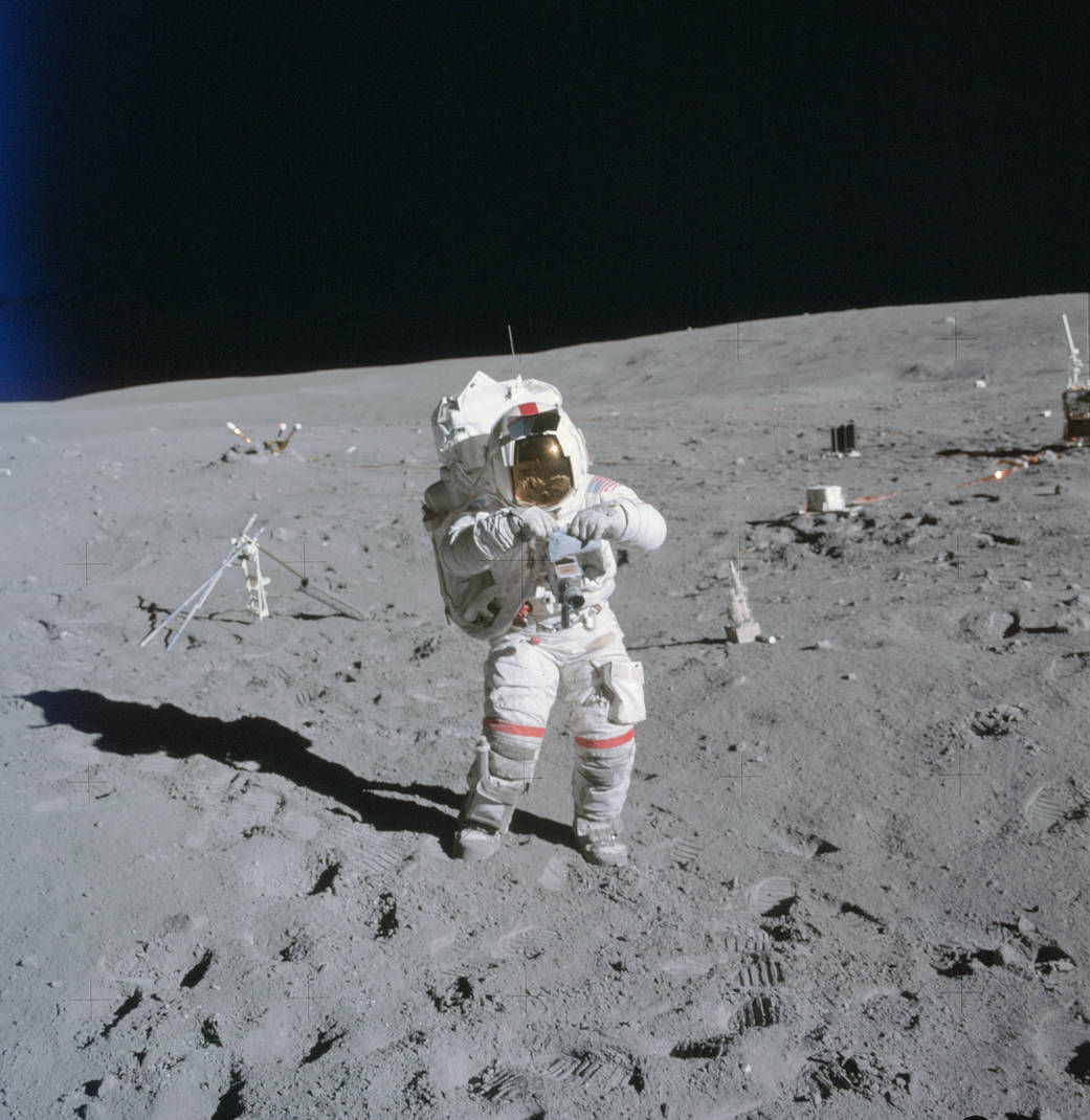 Astronaut in spacesuit walks on lunar surface