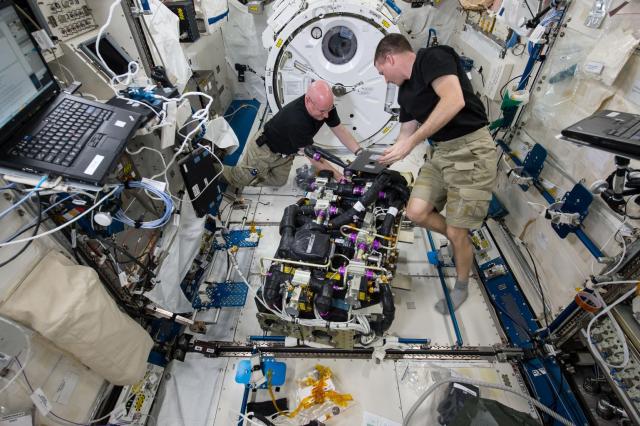 Astronauts work on the ISS