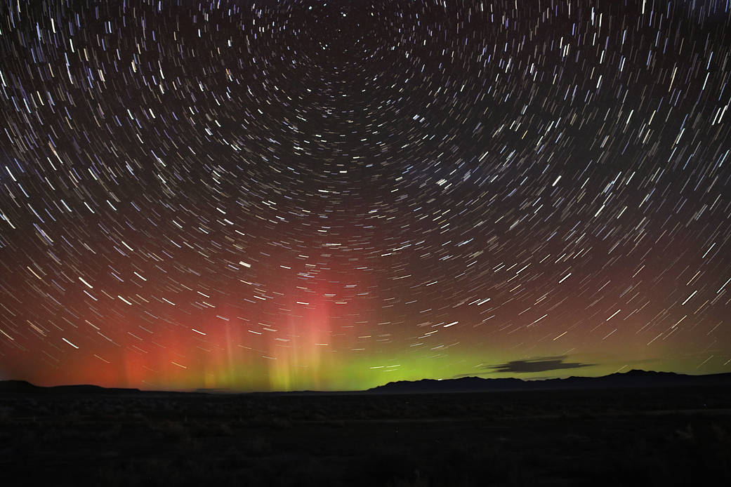 The aurora borealis glow on the northern horizon while stars wheel overhead in this long exposure, taken near the Bonneville Salt Flats in Utah on Nov. 4, 2021. 