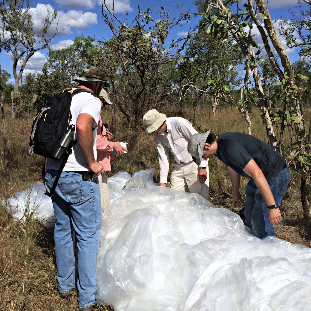 Researchers recover a balloon in the Australian outback, post flight.