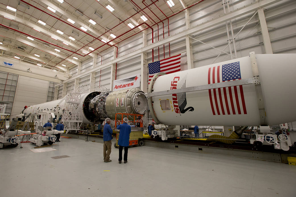 The payload fairing is installed on the Orbital Sciences Antares rocket at the Horizontal Integration Facility at NASA's Wallops