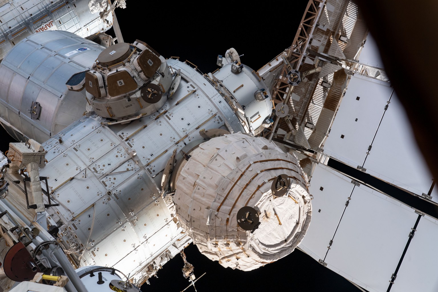 This view from a window on the International Space Station's Russian segment shows the Bigelow Expandable Activity Module (BEAM), the cupola with its seven windows shuttered, and the NanoRacks Bishop airlock. Behind the cupola is the Leonardo permanent multipurpose module. All four components are attached to the Tranquility module.
