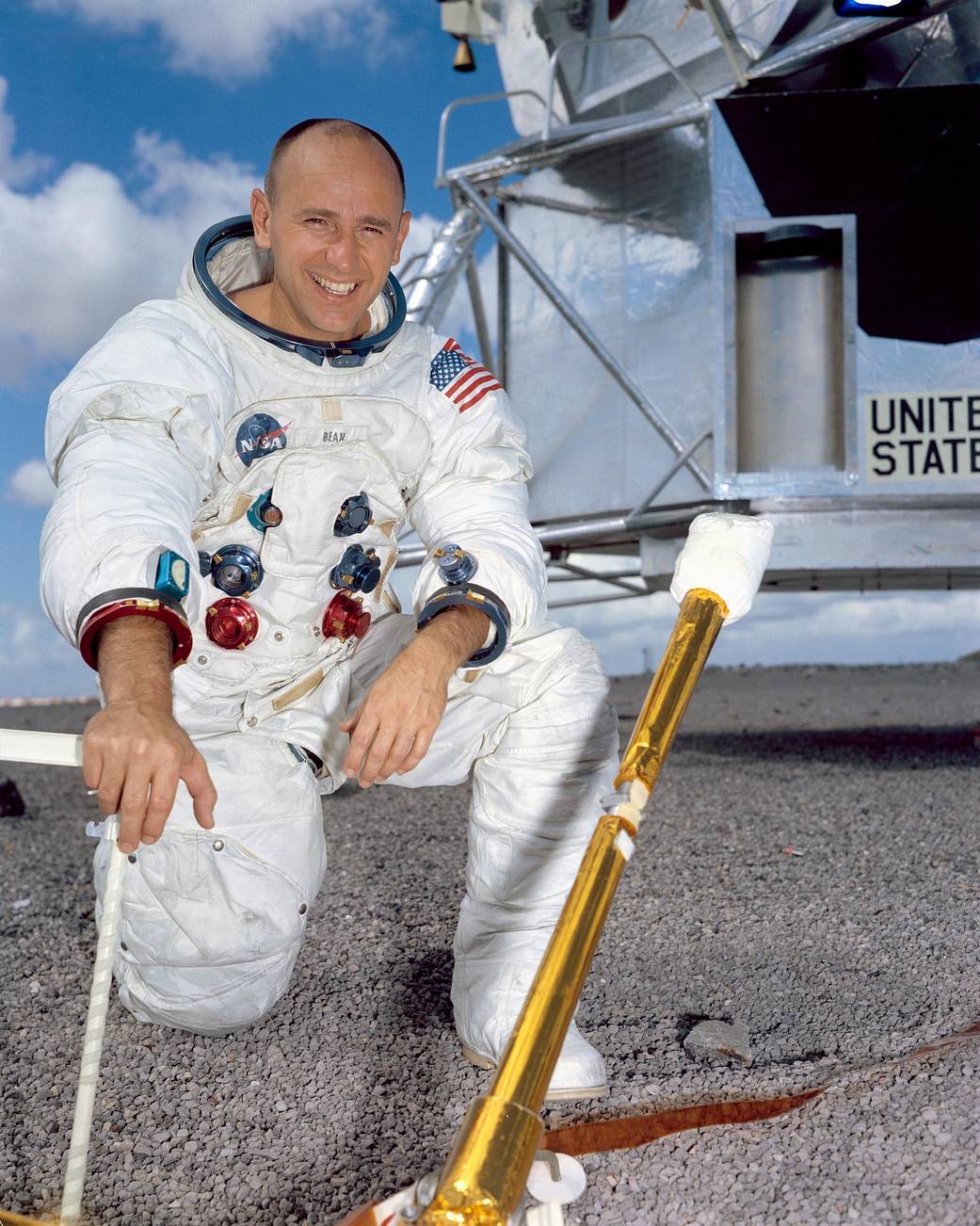Astronaut Alan Bean poses for a portrait in front of a mock-up of the Lunar Module.