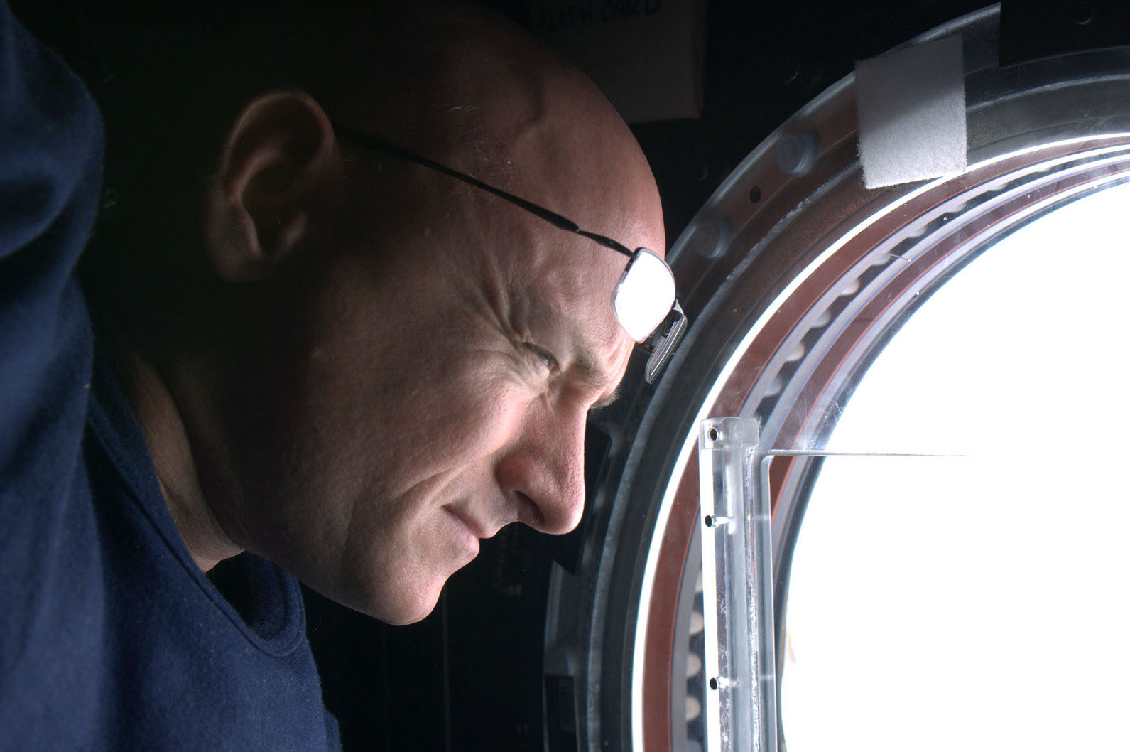 astronaut aboard ISS lookin out portal