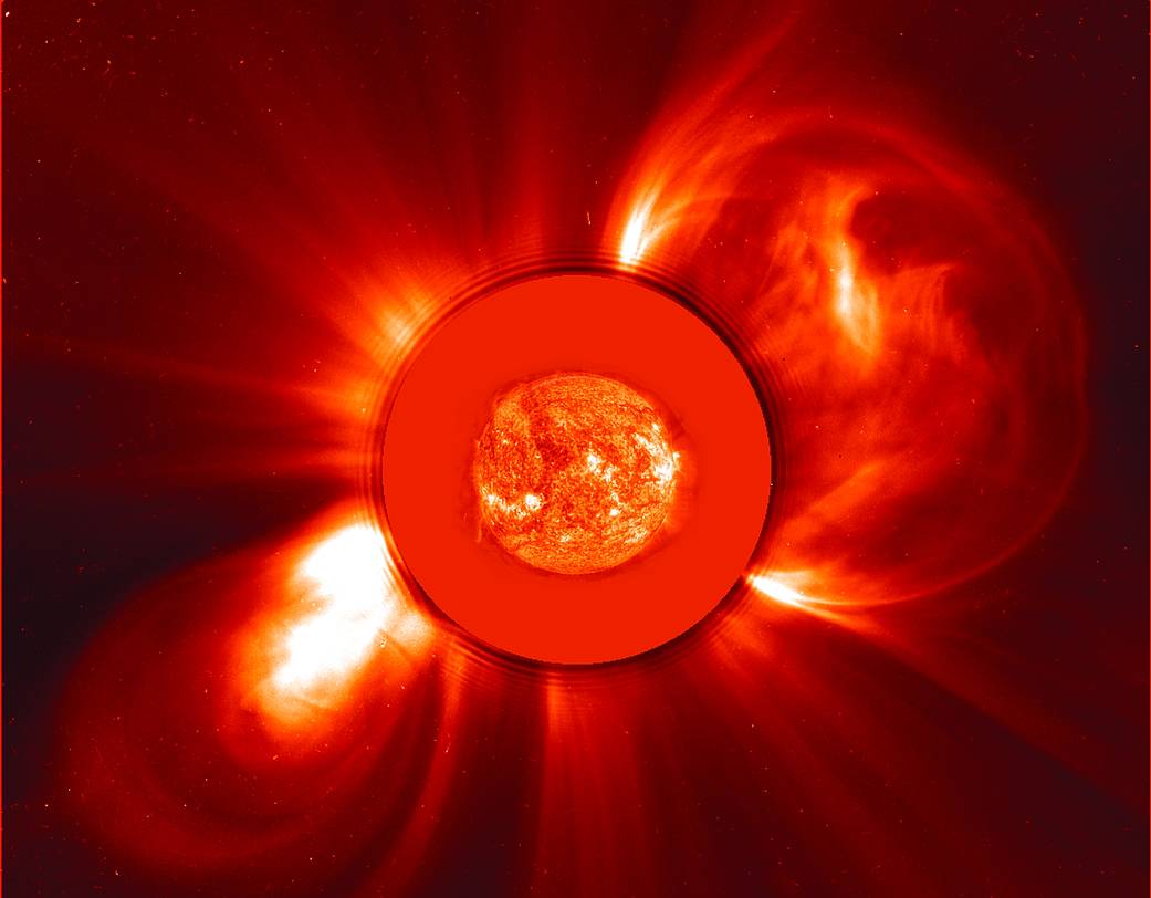 Image of sun from SOHO satellite showing two coronal mass ejections in opposite directions