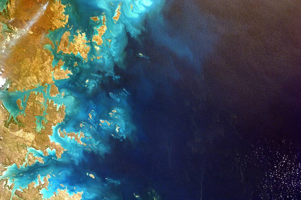 Blue water and coastline photographed from space station