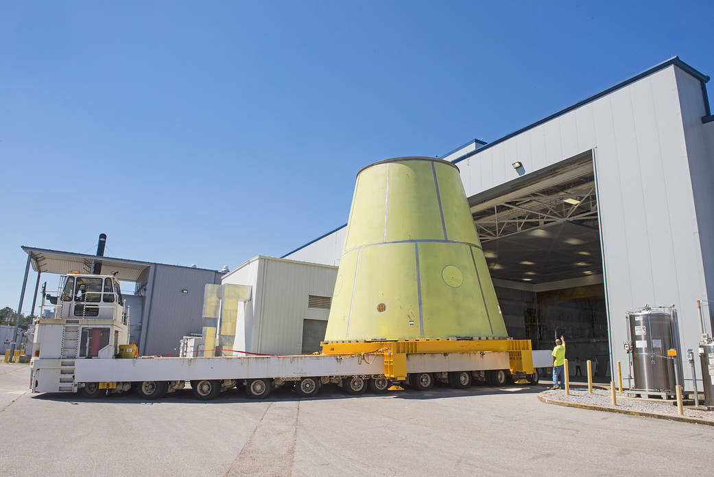 A NASA K-mag transporter tractor with 96 wheels hauls the Space Launch System’s launch vehicle stage adapter (LVSA).