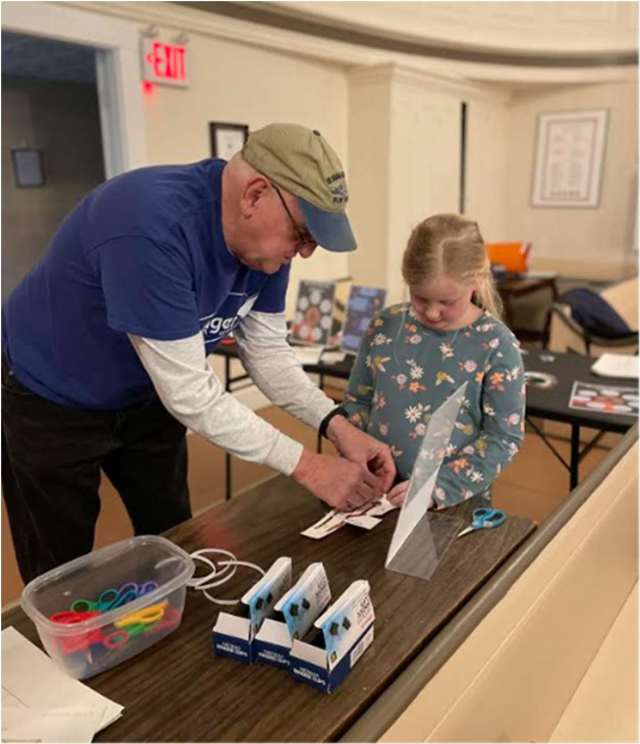 Challenger Learning Center of Maine’s volunteer Bill Shoppmeyer guides Cora as she creates the circuitry needed to light up her Ingenuity Mars Helicopter!