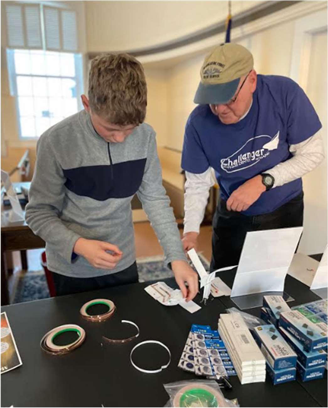 Hudson puts the finishing touches on his Ingenuity Mars Helicopter with volunteer, Bill Shoppmeyer, before it is ready a test flight!