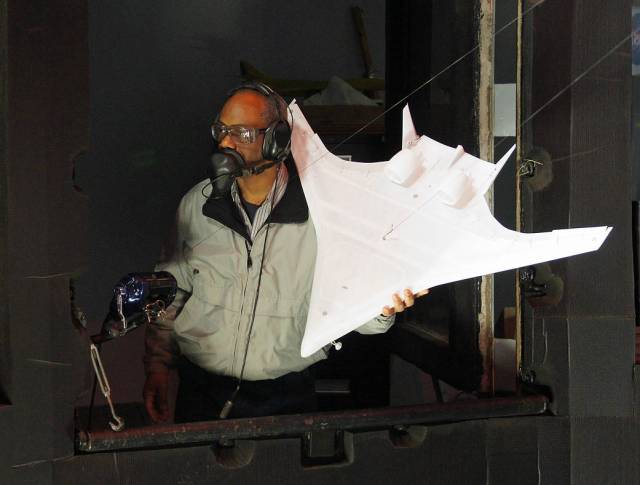Technician Clinton Duncan readies a Hybrid Wing Body model for tests in the NASA Langley spin tunnel in 2012. 