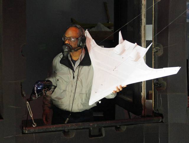 Technician Clinton Duncan readies a Hybrid Wing Body model for tests in the NASA Langley spin tunnel in 2012. 