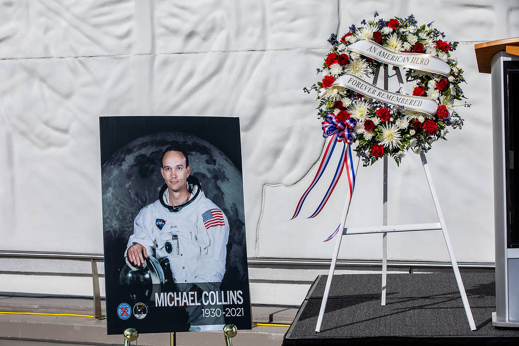A photo of Apollo and Gemini astronaut Michael Collins is seen next to a wreath honoring him at a ceremony April 30, 2021 at the Kennedy Space Cent...
