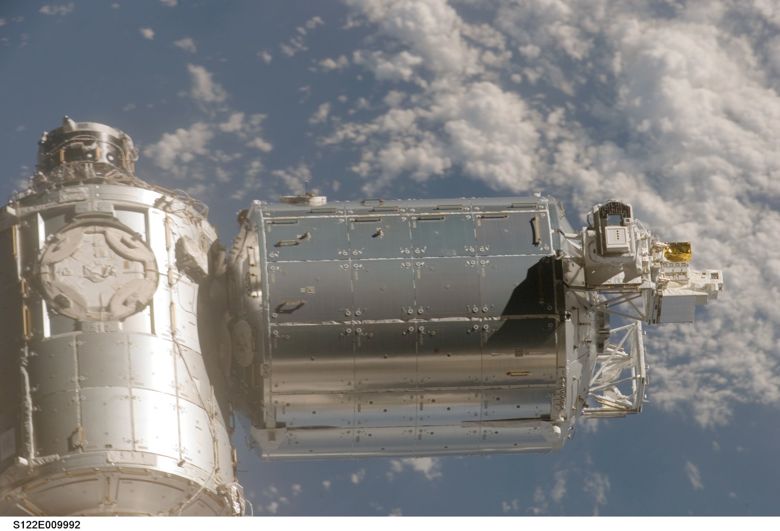 A close-up view of the Columbus laboratory (center) -- newest addition to the International Space Station -- is featured in this image photographed by a STS-122 crewmember on Space Shuttle Atlantis shortly after the undocking of the two spacecraft.