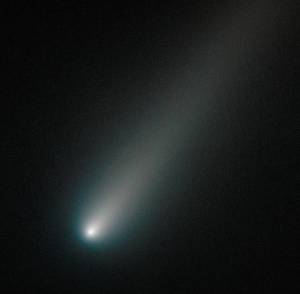 Bright comet streaks across dark space