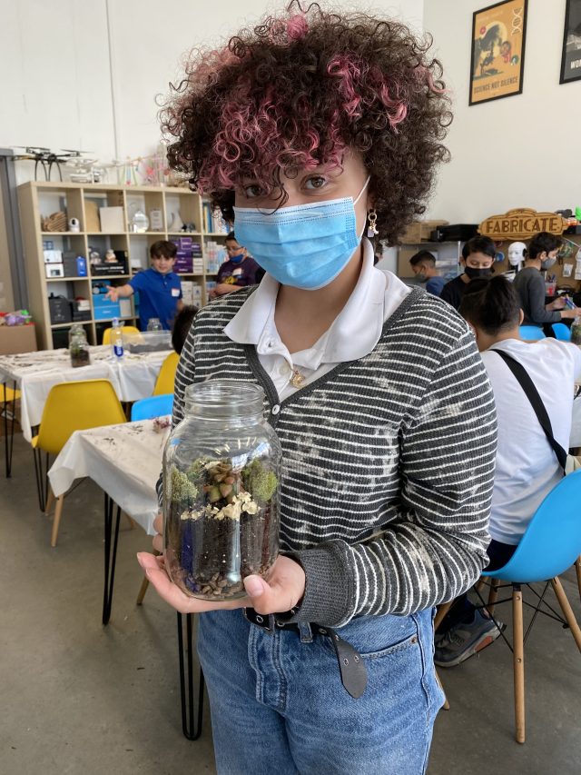Isabela Lopez shows off her terrarium creation, in which she designed a closed system for succulent plants and moss after learning about terraforming extraterrestrial environments during the World Water Day workshop in March 2022 at Fab Lab El Paso.