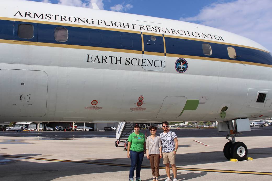 Program Scientists Shuyi Chen (center) poses in front of NASA’s DC-8 flying laboratory with two of her graduate students.