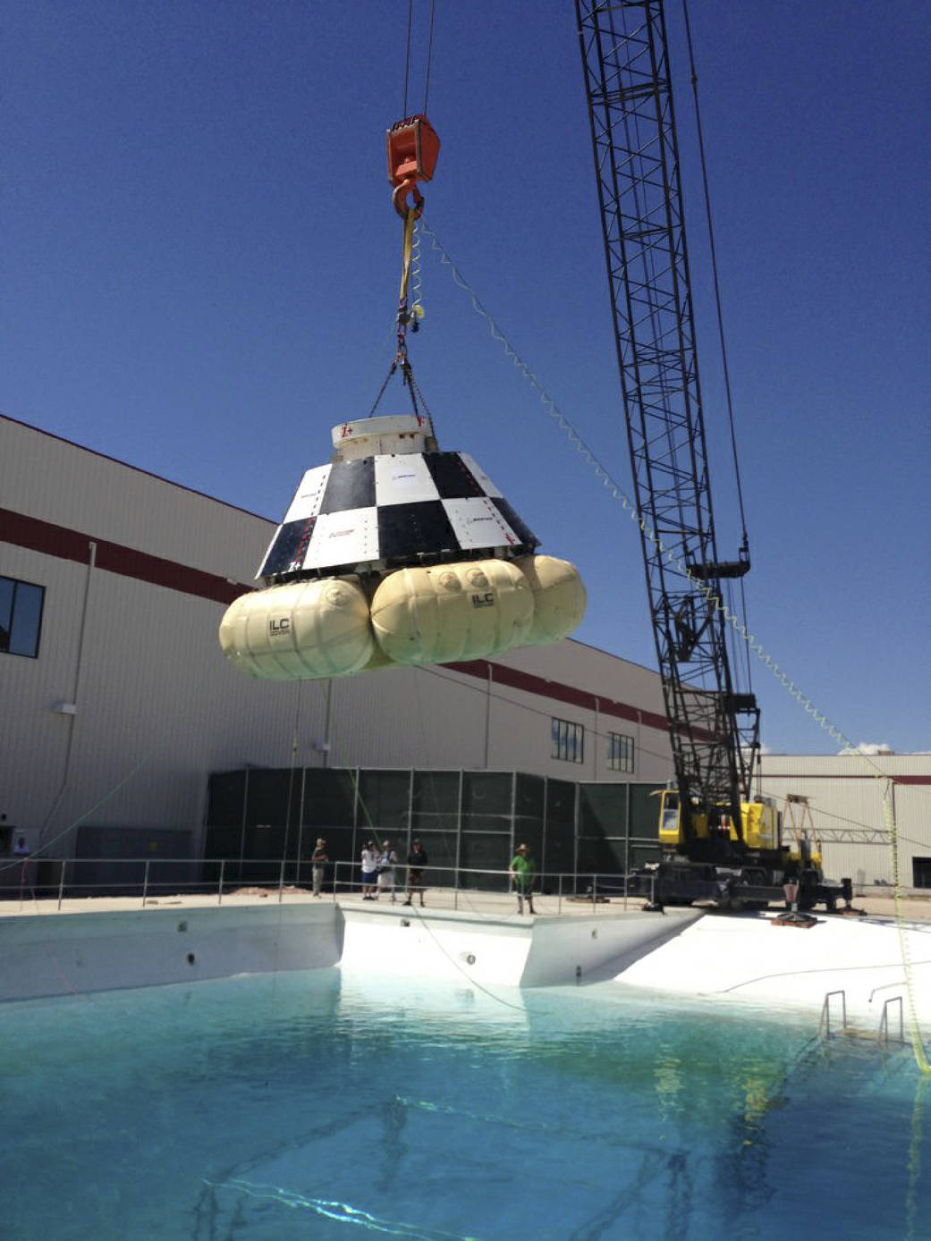 A mock-up of The Boeing Company's CST-100 spacecraft is prepared for a series of simulated contingency water landing scenarios