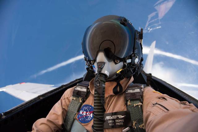 NASA photographer Carla Thomas in aircraft cockpit during supersonic flight