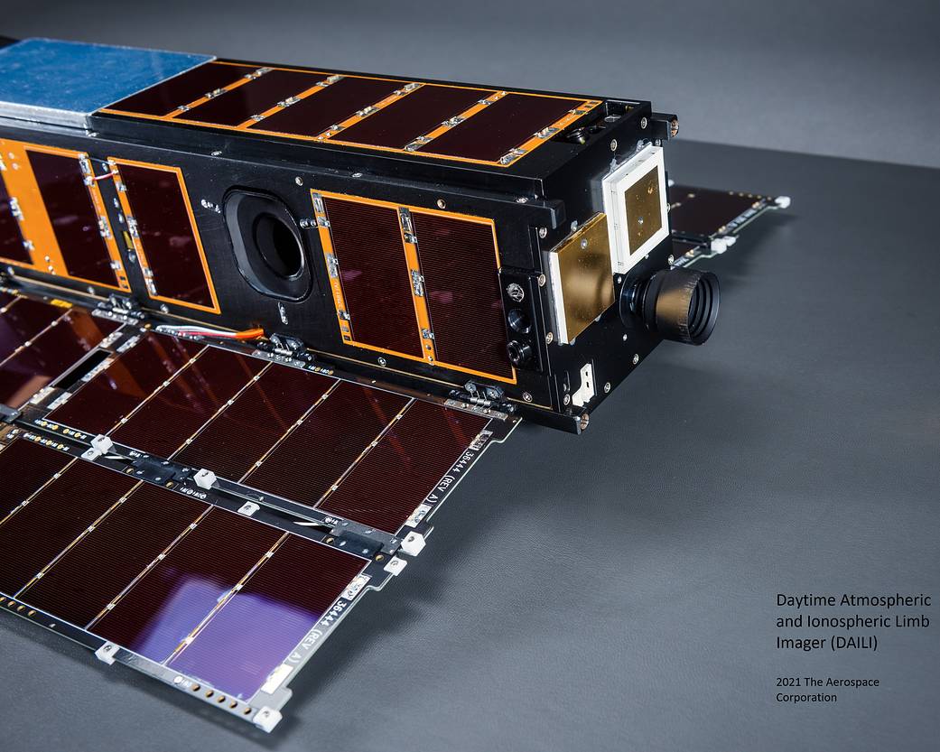 The DAILI CubeSat, with a lens sticking out from the front, and two wings deployed on the sides of it.