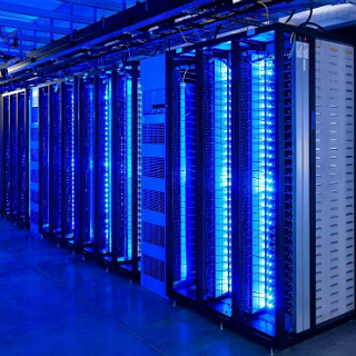 Neon dark blue IT server racks lined up in a row.