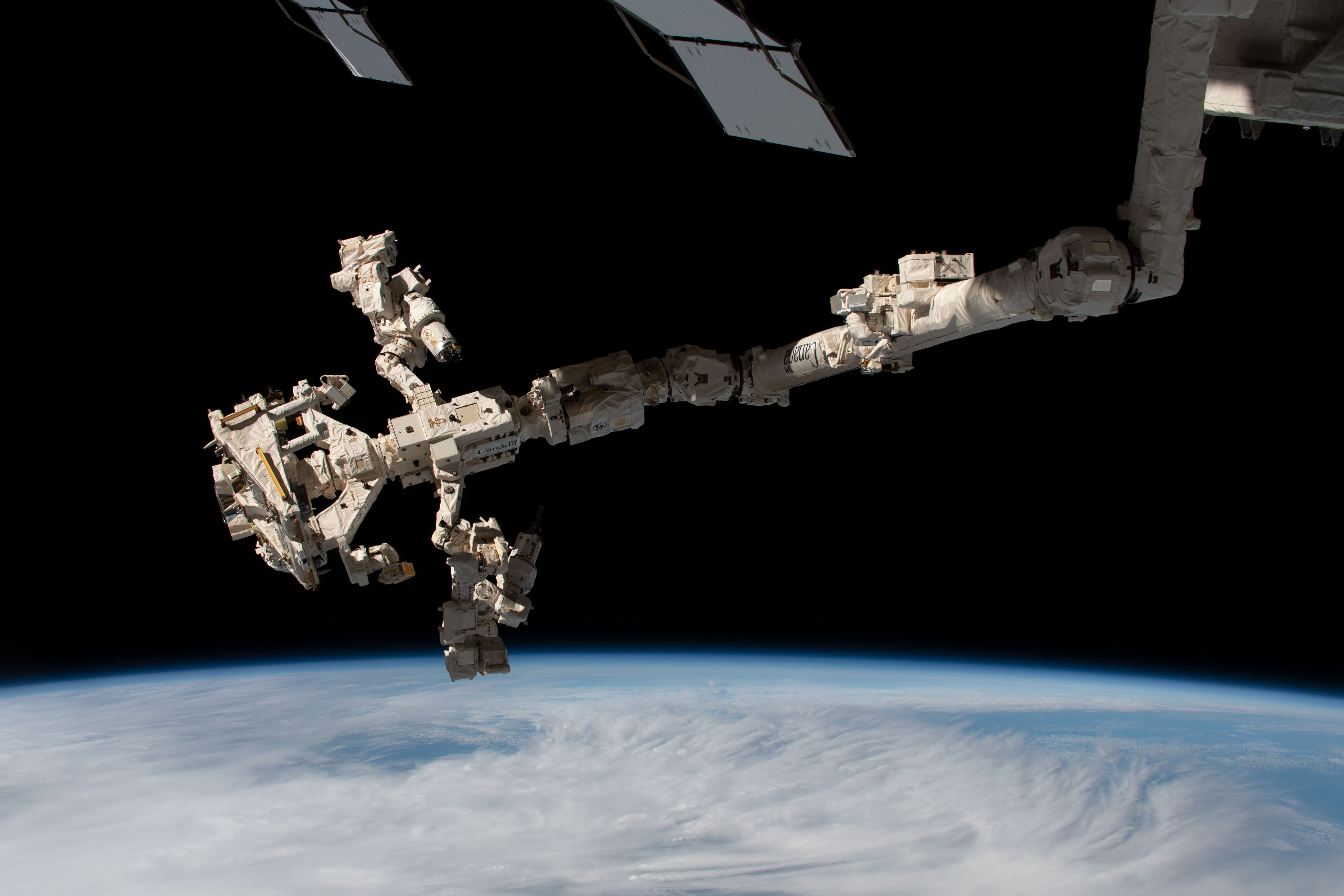 Dextre, the International Space Station's fine-tuned robotic hand, is pictured attached to the Canadarm2 robotic arm.