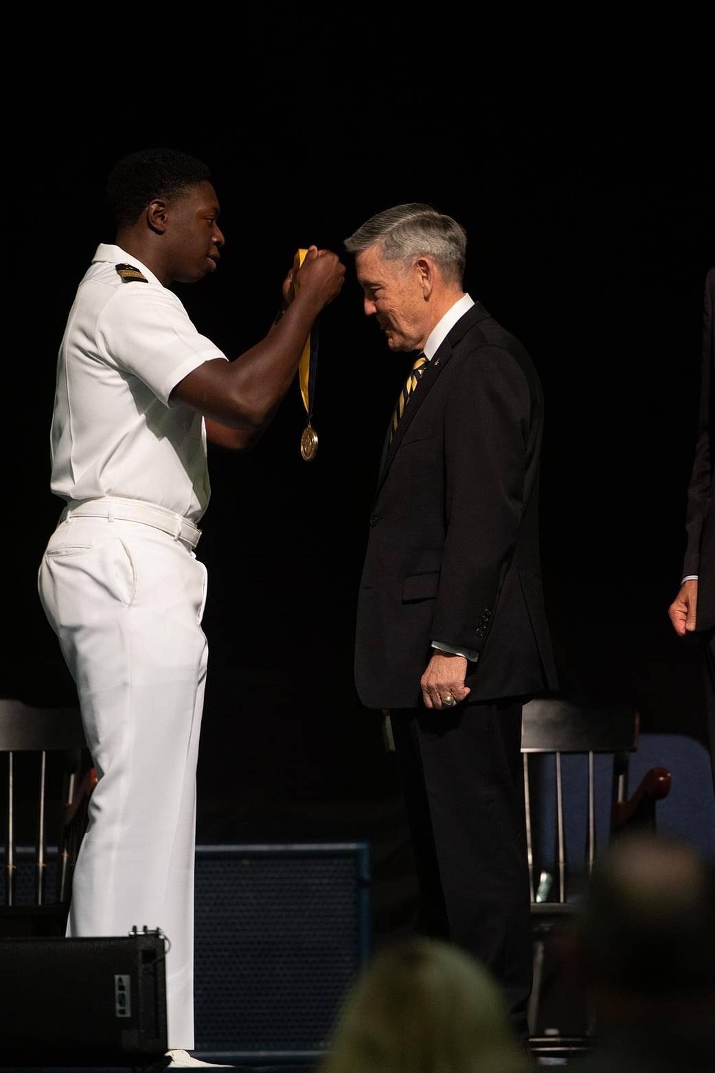 Midshipman Jackie Booker from the U.S. Naval Academy presented NASA Associate Administrator Bob Cabana with a Distinguished Graduate Medal 