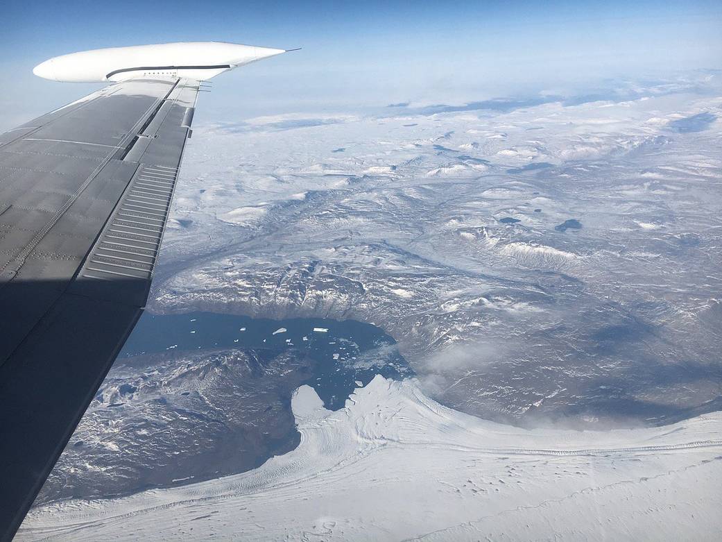 Photo from aircraft window showing glaciers below