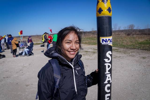Stephanie Yazzie, Northern Arizona University student and NAU Space Jacks team member, poses with her team’s rocket in this photo from the 2019 NASA First Nations Launch (FNL) competition.