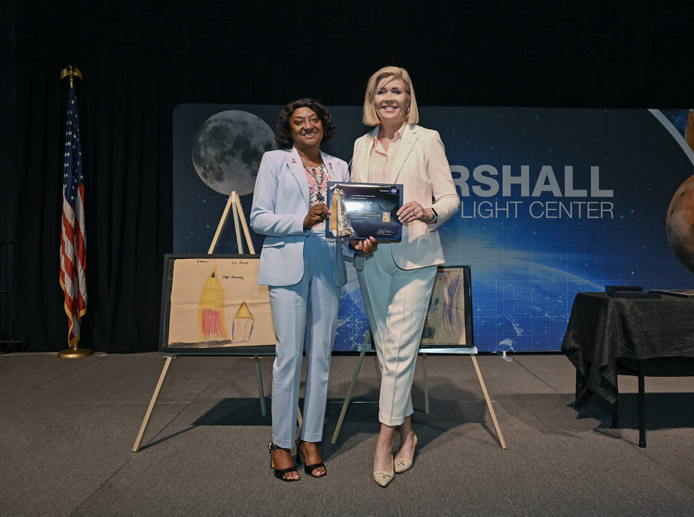 NASA Equal Employment Manager Carolyn Magsby, left, presents Hurley with a certificate of appreciation