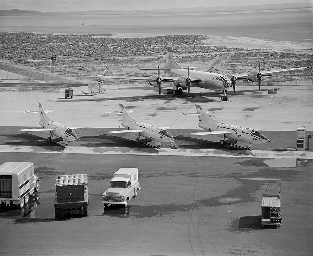 Behind three Douglas D-558-IIs planes is a B-29 launch aircraft. 