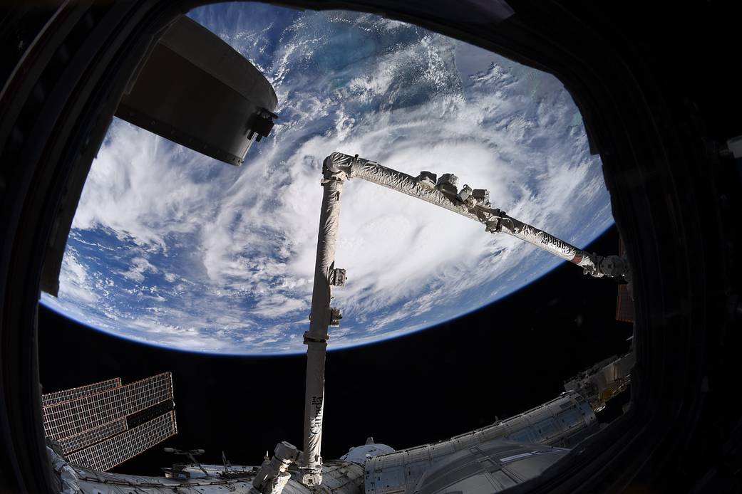 Tropical Storm Elsa photographed from space station with Canadarm2 robotic arm visible
