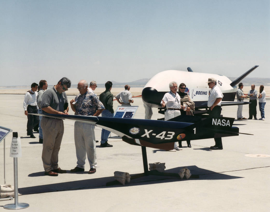 Aerospace industry representatives view actual and mock-up versions of X-Planes.