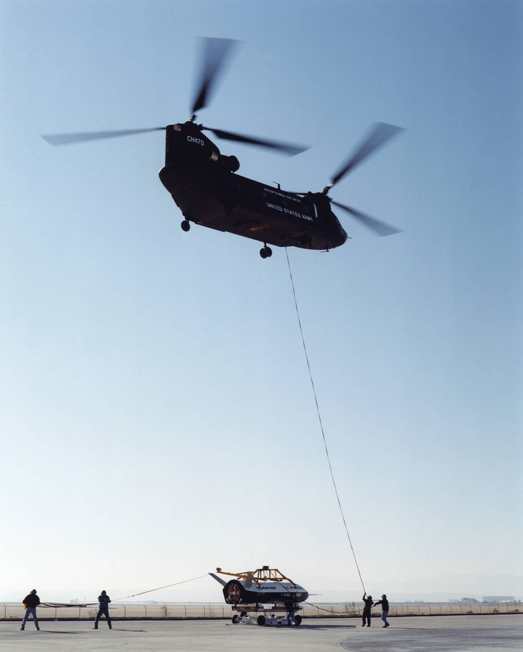 Wranglers steadied the X-40A during an unpiloted glide flight. 
