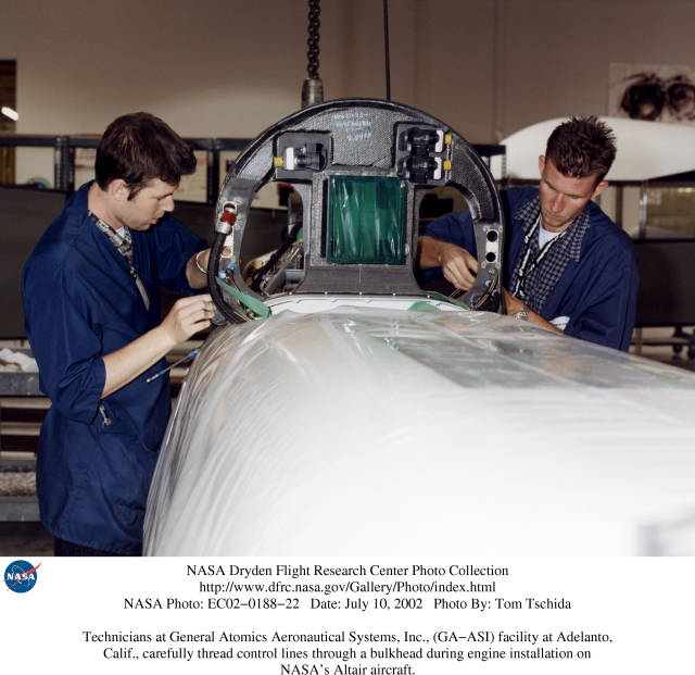 Technicians at General Atomics Aeronautical Systems, Inc., (GA-ASI) facility at Adelanto, CA, thread control lines