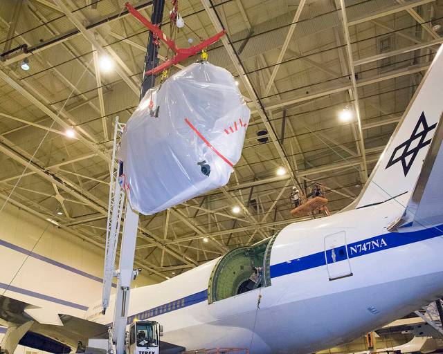 SOFIA’s 9-foot mirror is lowered into the cavity on the aircraft.