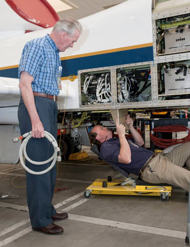 Technicians Measure Mounts to Install Scientific Equipment