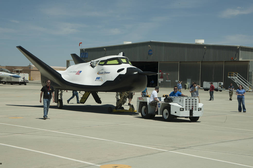 Sierra Nevada Corporation's Dream Chaser flight test vehicle is towed from its hangar at NASA's Dryden Flight Research Center in