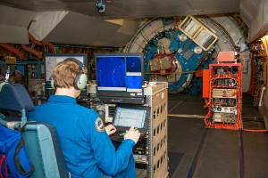 Senior Scientist at SOFIA Science Center, conducting observations onboard SOFIA facing the telescope’s Naysmith foci “eyepiece.”