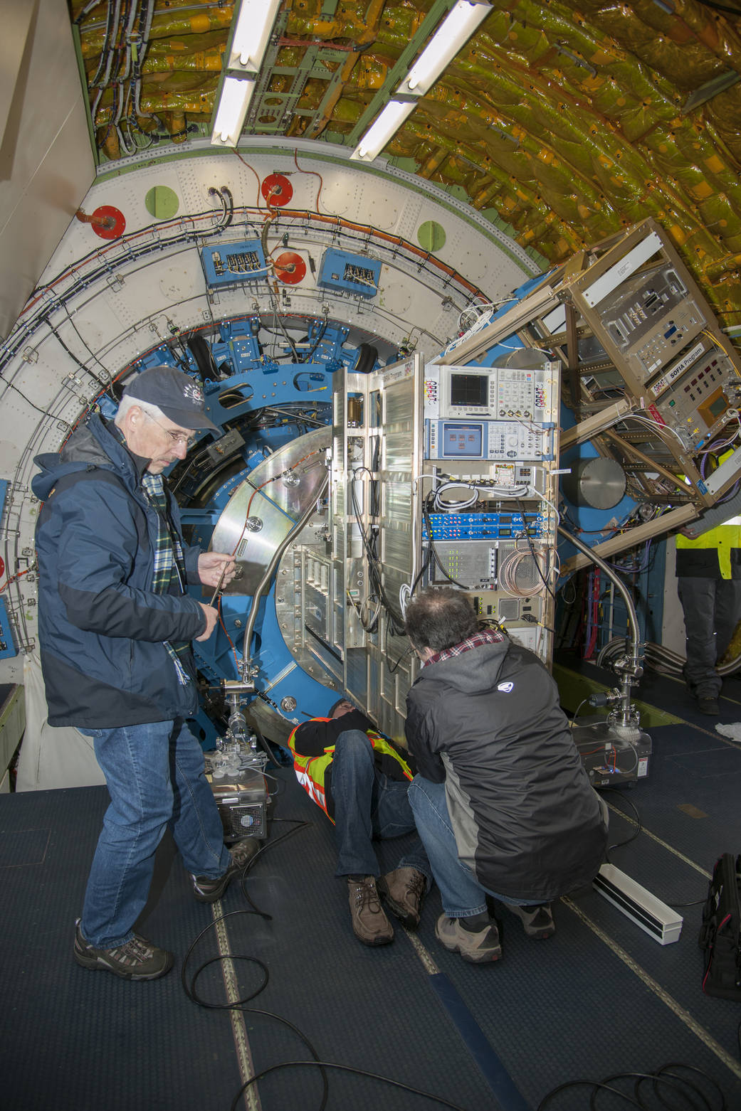 Karl Jacobs (left), Oliver Ricken (center on floor) and Urs Graf prepare the German Receiver for Astronomy at Terahertz Frequenc
