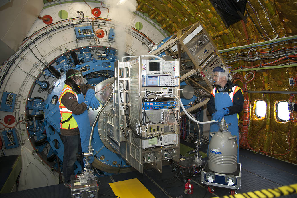 Christophe Risacher (left) and Karl Jacobs cool the GREAT spectrometer with a liquid cryogen in preparation for a flight of the 