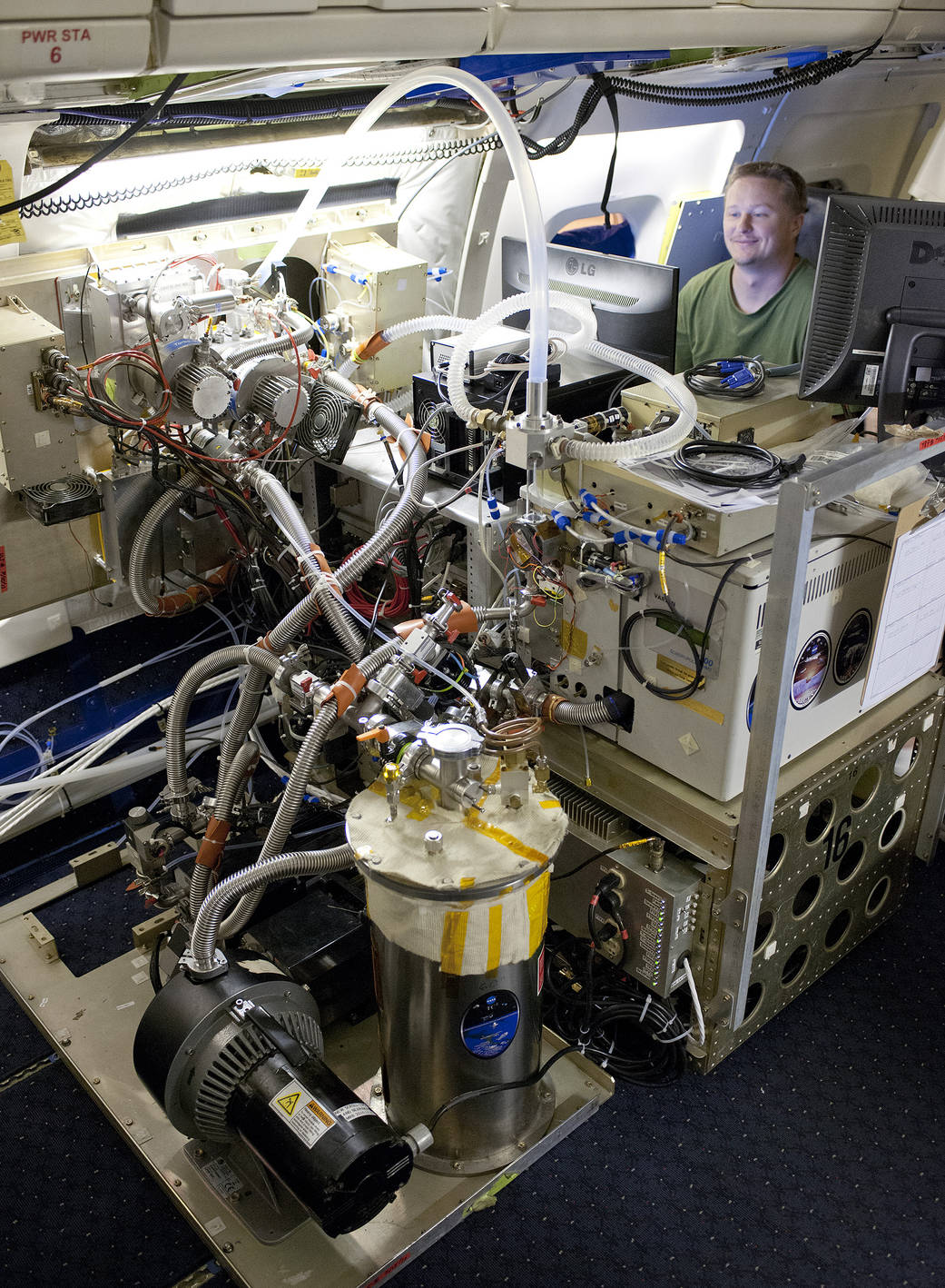 Researcher Checks Out Chemical Ionization Mass Spectrometer