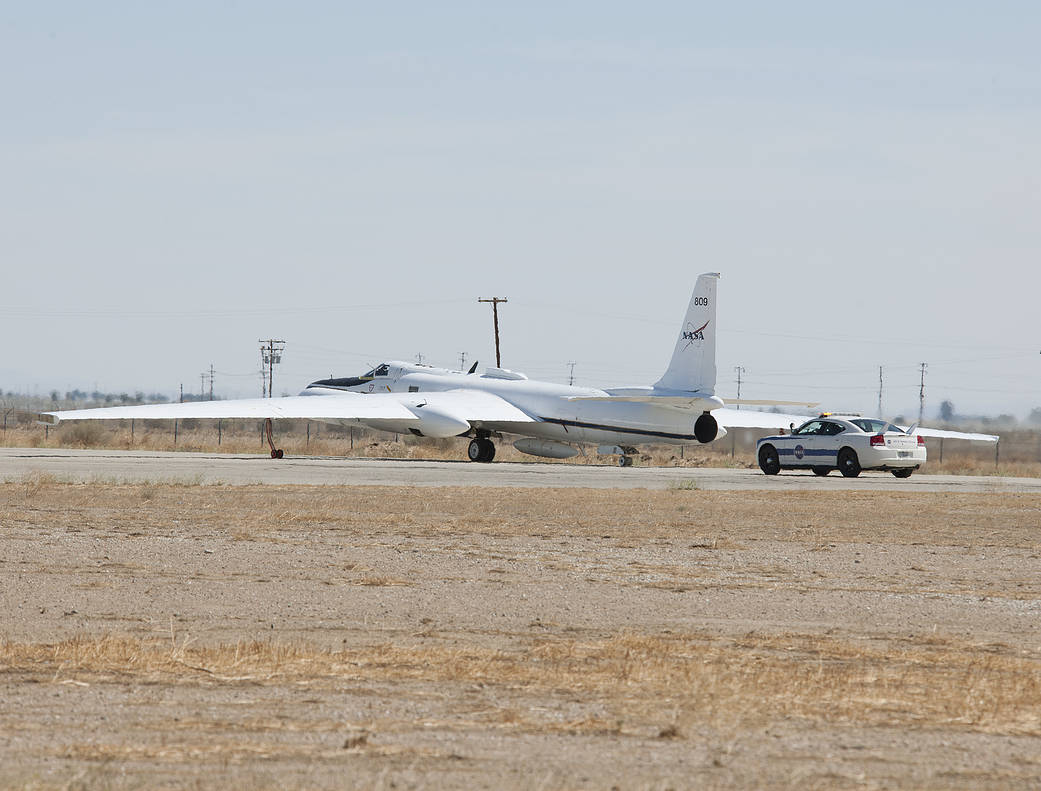 NASA's high-altitude ER-2 taxis to the runway of Air Force Plant 42 in Palmdale, Calif. Following is a NASA chase vehicle driven