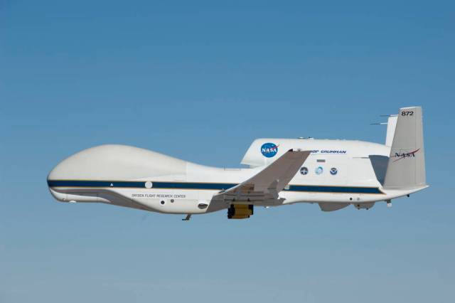Two small yellow-and-black pods beneath the wings of NASA's Global Hawk No. 872 house the Hawkeye cloud particle probe instrumen