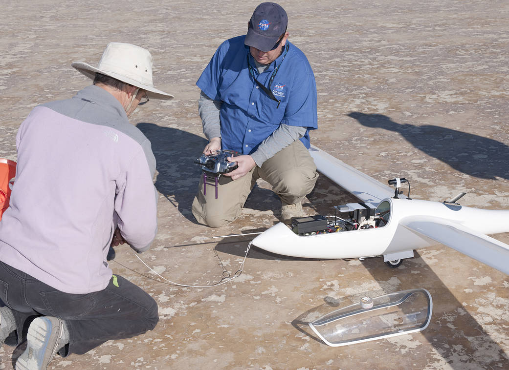 Principal investigator Jim Murray prepares the towline while operations engineer Red Jensen checks out the radio controller for 