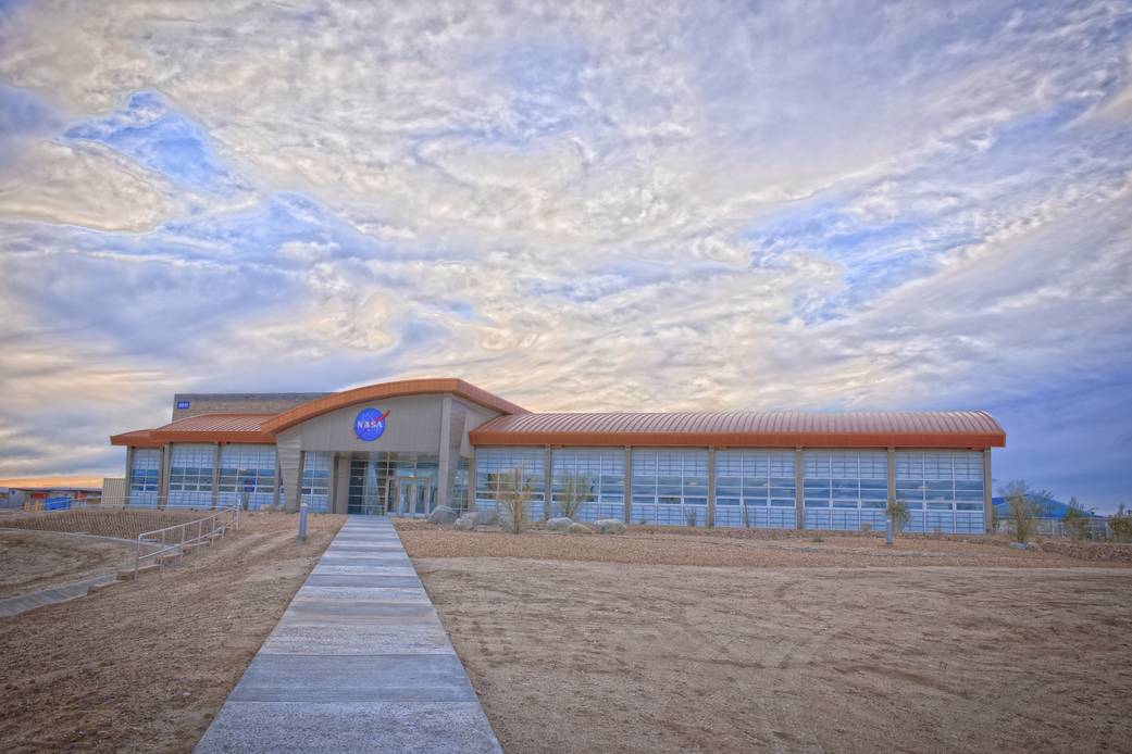 Late afternoon clouds on a winter afternoon provide a dramatic backdrop in this front view of the new Facilities Support Center 